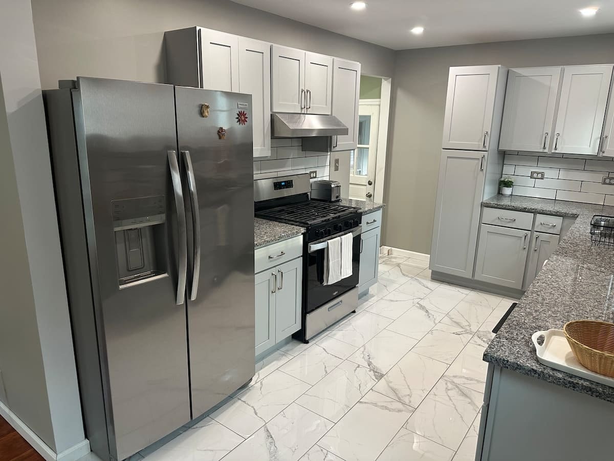 The home's kitchen with full-size appliances and gray cabinetry